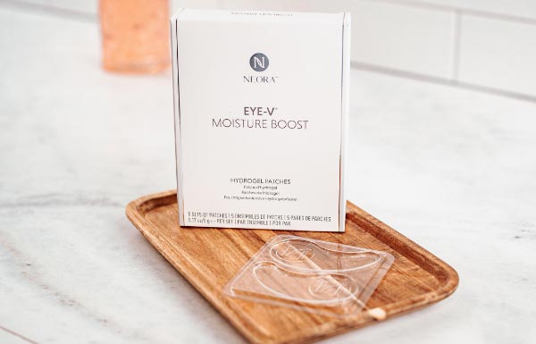 Image of Eye-V™ Moisture Boost Hydrogel Patches on wooden tray in bathroom.